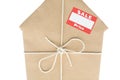 House Wrapped In Brown Paper With Sale Sticker