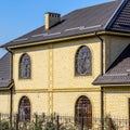 House of yellow brick and brown corrugated windows Royalty Free Stock Photo