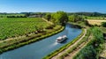 Houseboat in Canal du Midi aerial drone view from above, family water travel by boat, vacation in Southern France Royalty Free Stock Photo