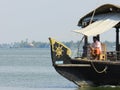 Houseboat captain making headway in backwater near Alleppey, Kerala, India