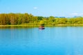 Houseboat on the lake, and trees in the background. Royalty Free Stock Photo