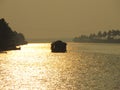 A houseboat sailing during sunset at Alleppy Backwaters, Kerala, India