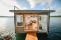 A houseboat sitting on top of a body of water. AI generative image. Tiny house, houseboat.