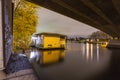 Houseboat situated under a bridge in the Amstel river in Amsterdam Royalty Free Stock Photo