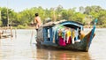 Houseboat with young man paddling, Vietnam.