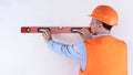 Housebuilder Using Building Level Standing Back To Camera, White Background Royalty Free Stock Photo