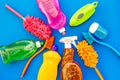 Housecleaner tools set with detergents, soap, cleaners and brush on blue background top view mock up