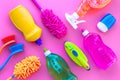 Housecleaner tools set with detergents, soap, cleaners and brush on pink background top view mock up