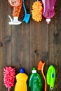 Housecleaner tools set with detergents, soap, cleaners and brush on wooden background top view mock up