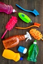 Housecleaner tools set with detergents, soap, cleaners and brush on wooden background top view mock up