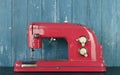 Household appliances - Front view retro red sewing machine wooden background Royalty Free Stock Photo