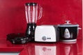 Household appliances in modern kitchen red background Royalty Free Stock Photo