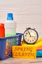 Household cleaning products and alarm clock. Royalty Free Stock Photo