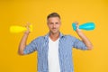 Household cleaning products kill coronavirus. Happy guy hold spray bottles. Using household cleaners and disinfectants Royalty Free Stock Photo