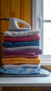 Household efficiency Stack of clothes and electric iron on board Royalty Free Stock Photo