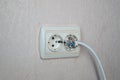 Household electrical outlet with a broken electrical plug inside Royalty Free Stock Photo