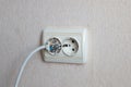 Household electrical outlet with a broken electrical plug inside. Bare live wires sticking out of the Electric socket Royalty Free Stock Photo
