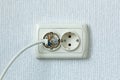 Household electrical outlet with a broken electrical plug inside. Wiring Devices Royalty Free Stock Photo