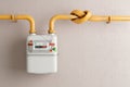 Household gas meter with a pipeline on the wall twisted into a knot. 3D render Royalty Free Stock Photo