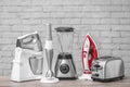 Household and kitchen appliances on table Royalty Free Stock Photo