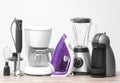 Different household and kitchen appliances on table against light background. Interior element Royalty Free Stock Photo