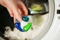 Close up holding gel cap for washing machine. Royalty Free Stock Photo