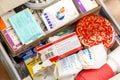 Household medicine drawer full of medication storage closeup, top view Lots of different containers and medicine packs