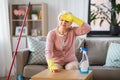 Tired senior woman cleaning table at home Royalty Free Stock Photo