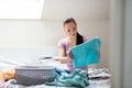 Woman or housewife sorting laundry at home Royalty Free Stock Photo