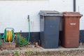 Household plastic recycling bins against a wall Royalty Free Stock Photo
