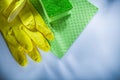 Household washcloth sponge protective gloves on white surface Royalty Free Stock Photo