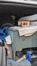 Household waste packed into a van on a rainy day Royalty Free Stock Photo