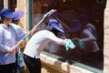 Housekeeper cleaning glass in hotel Royalty Free Stock Photo