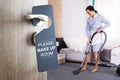 Housekeeper Cleaning Hotel Room Royalty Free Stock Photo