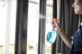 Housekeeper cleaning a hotel window Royalty Free Stock Photo