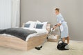 Housekeeper Cleaning With Vacuum Cleaner Royalty Free Stock Photo