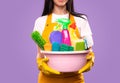 Housekeeper with detergents and cleaning supplies