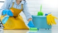 Housekeeper maid wearing rubber gloves with cloth cleaning or applying floor care and cleaners at home, housework and housekeeping