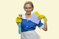 Housekeeper in uniform holding cleaning supplies.