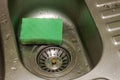 Housekeeper washes dirty washbasin with washcloth