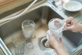 Housekeeper washing a dishes.