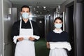 housekeepers in uniform and medical masks