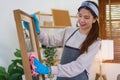 Housekeeping concept, Housemaid wear glove and use cloth to cleaning the glass while cleaning house