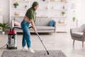 Low section of woman cleaning carpet with vacuum cleaner Royalty Free Stock Photo