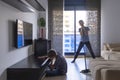 Housekeeping and household. Kids clean living room. Child cleans dust from furniture, brother plays and singing at mop Royalty Free Stock Photo