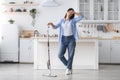Tired woman cleaning floor with mop in kitchen Royalty Free Stock Photo