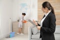 Housekeeping manager checking maid work Royalty Free Stock Photo