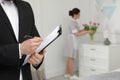 Housekeeping manager checking maid work in hotel room Royalty Free Stock Photo