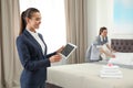 Housekeeping manager with tablet checking maid work in hotel room Royalty Free Stock Photo