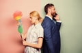 Housekeeping routine. Housewife and businessman. Career and housekeeping. Family couple. Wife stand with dust brush